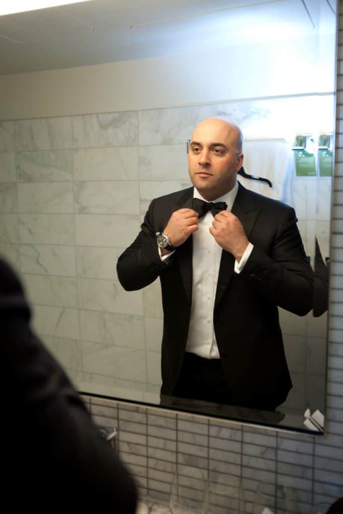 trevor getting ready in his custom wedding tuxedo