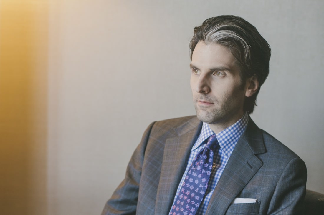 Man wearing pinstripe suit in chair