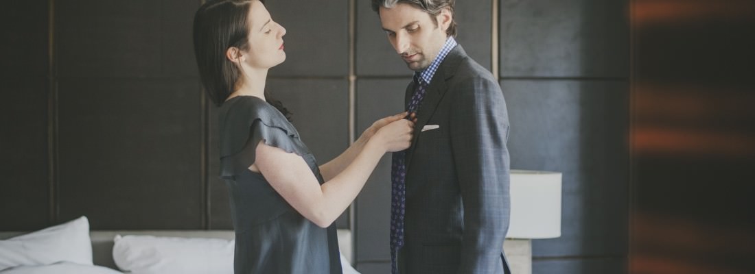lady helping man tie his tie