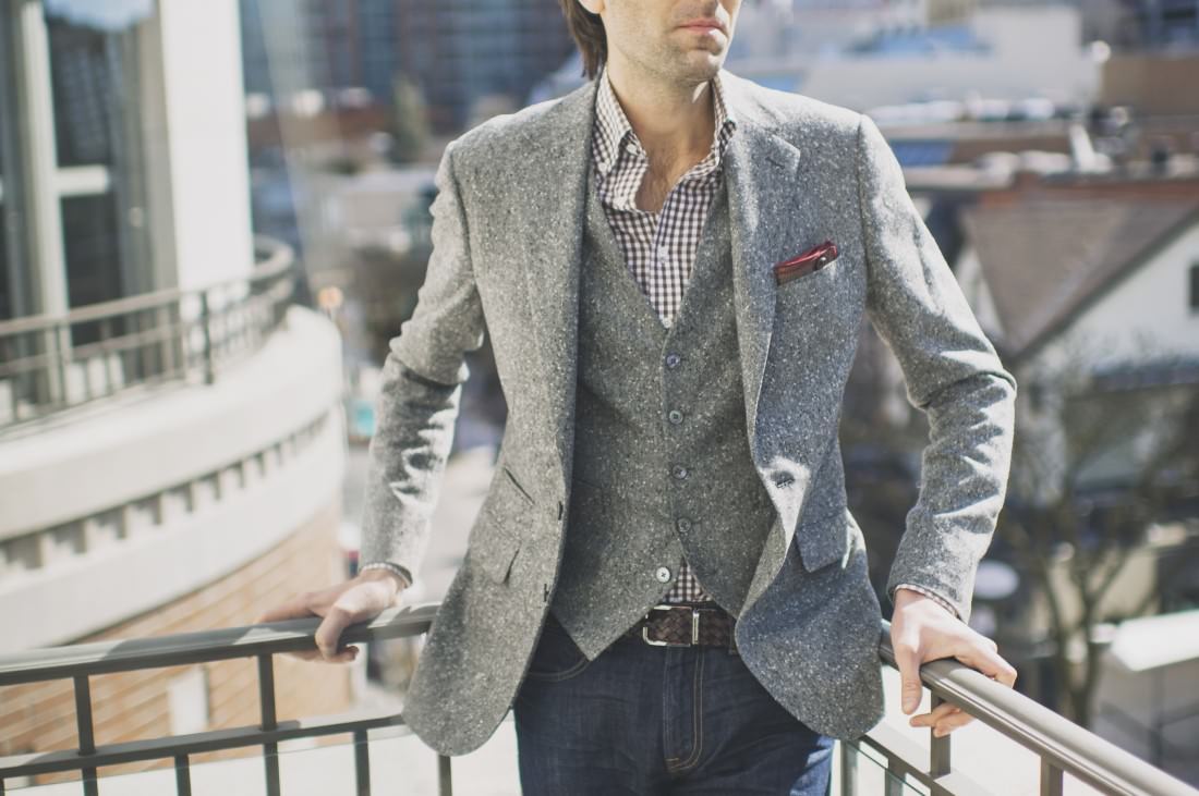 man in tweed suit standing outside