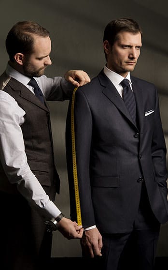 tailor measuring mans arm